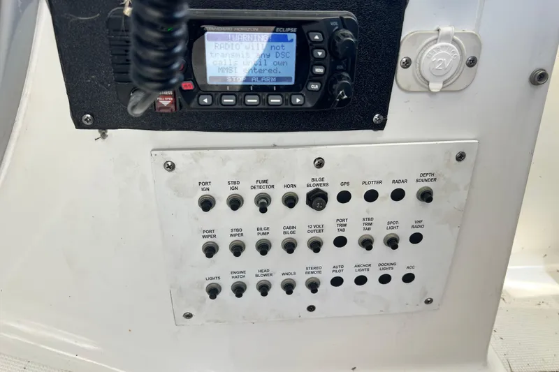 Slide: The Image of Control panel of a 2006 Formula 40 Performance Cruiser with various switches and a radio display. - 40