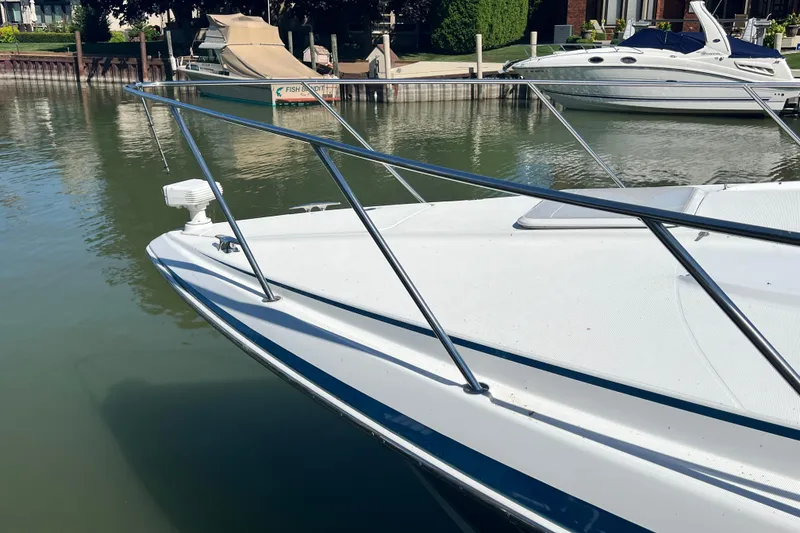Slide: The Image of 2006 Formula 40 Performance Cruiser docked in a marina, showcasing sleek design and railing. - 52