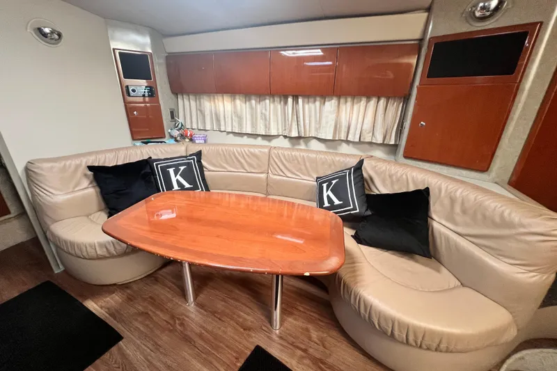 Slide: The Image of Luxurious interior of a 2006 Formula 40 Performance Cruiser with leather seating and wooden table. - 56