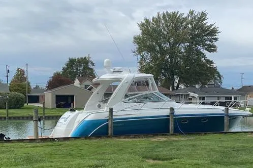 Slide: The Image of 2006 Formula 40 Performance Cruiser docked by a grassy shoreline. - 67