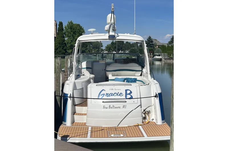 Slide: The Image of 2006 Formula 40 Performance Cruiser docked, rear view with seating area, clear sky. - 7