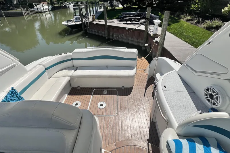 Slide: The Image of 2006 Formula 40 Performance Cruiser with spacious seating and wooden deck by the water. - 8