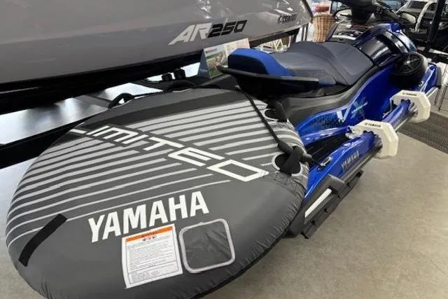 Slide: The Image of 2026 Yamaha WaveRunner VX Limited HO with inflatable tube accessory, displayed indoors. - 2