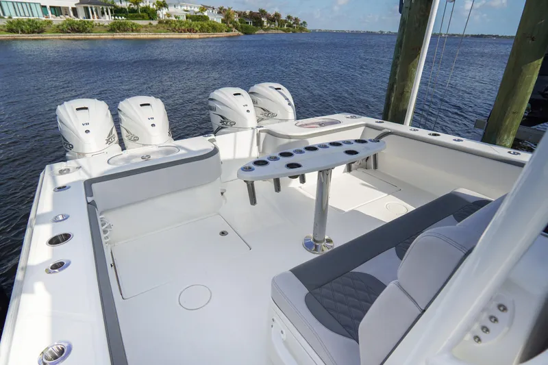 Slide: The Image of 2022 SeaHunter 41 CTS boat with four powerful outboard engines docked by the water. - 10