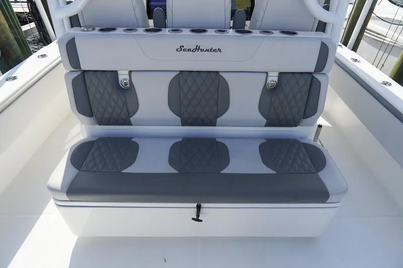 Slide: The Image of Luxury seating on 2022 SeaHunter 41 CTS boat, featuring quilted gray upholstery. - 11