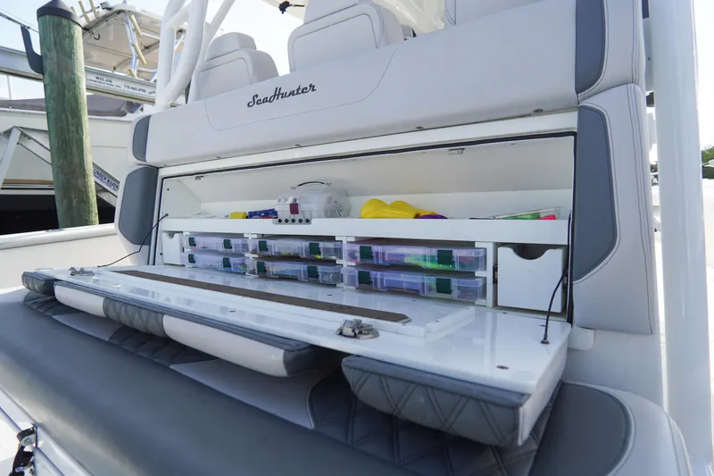 Slide: The Image of 2022 SeaHunter 41 CTS boat with organized storage compartments and fishing gear. - 12