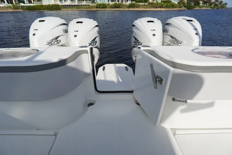 Slide: The Image of 2022 SeaHunter 41 CTS boat with four Yamaha XTO V8 engines on a calm waterway. - 13