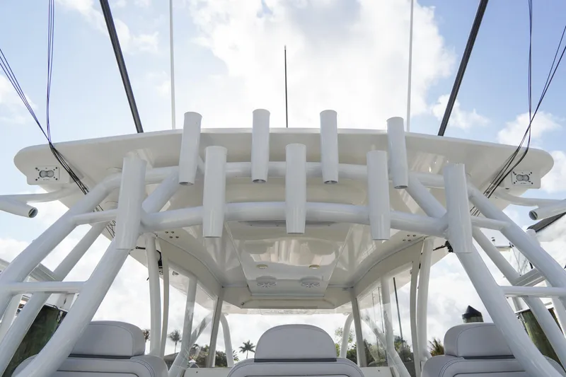 Slide: The Image of 2022 SeaHunter 41 CTS boat with rod holders and sleek design against a cloudy sky. - 16