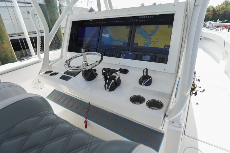 Slide: The Image of 2022 SeaHunter 41 CTS boat dashboard with navigation screens and controls. - 19