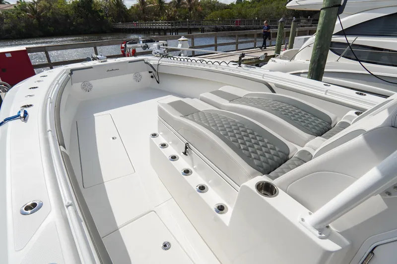 Slide: The Image of 2022 SeaHunter 41 CTS boat interior with cushioned seating and sleek design. - 22