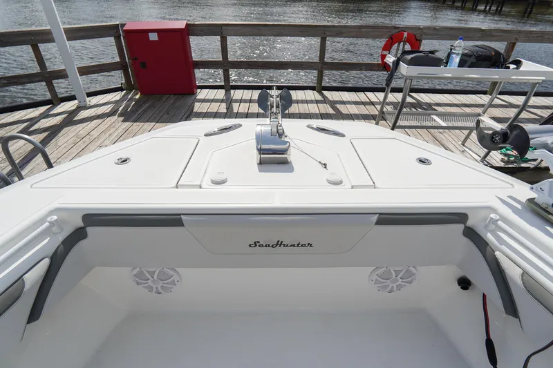 Slide: The Image of 2022 SeaHunter 41 CTS boat docked, showcasing spacious deck and sleek design. - 23