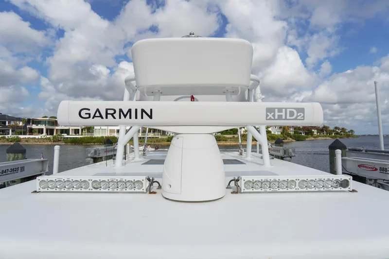 Slide: The Image of 2022 SeaHunter 41 CTS boat with Garmin xHD2 radar, docked by waterfront homes. - 28