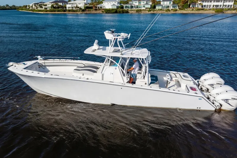 Slide: The Image of 2022 SeaHunter 41 CTS boat cruising on a calm waterway with scenic background. - 3