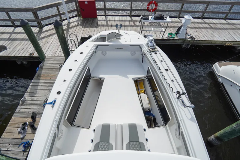 Slide: The Image of 2022 SeaHunter 41 CTS boat docked, showcasing spacious deck and storage compartments. - 32