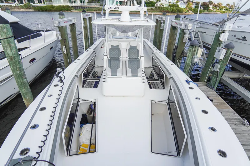 Slide: The Image of 2022 SeaHunter 41 CTS boat docked, featuring spacious deck and storage compartments. - 33