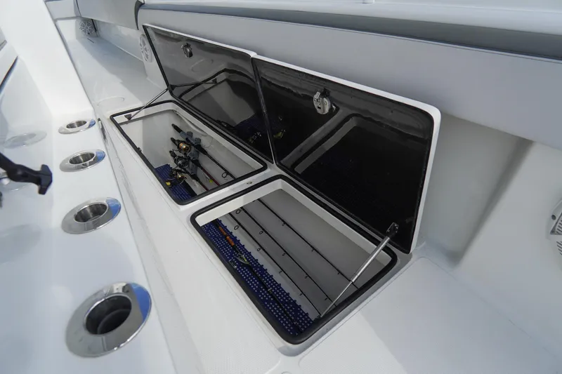 Slide: The Image of 2022 SeaHunter 41 CTS boat with open storage compartments and fishing rods. - 36