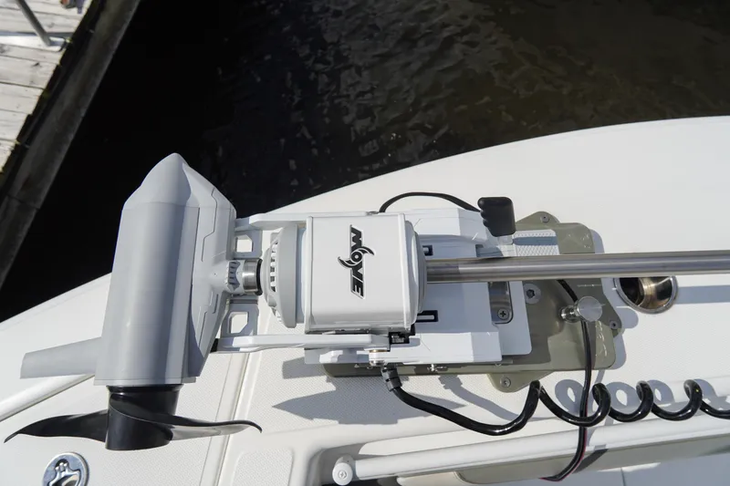 Slide: The Image of Trolling motor on 2022 SeaHunter 41 CTS boat, docked by the water. - 37
