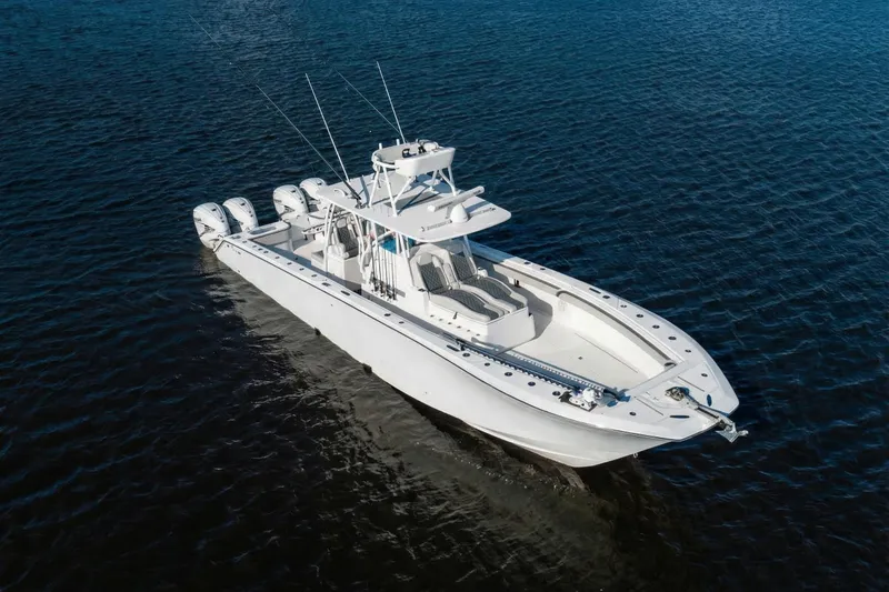 Slide: The Image of 2022 SeaHunter 41 CTS boat on open water, featuring multiple outboard engines. - 6