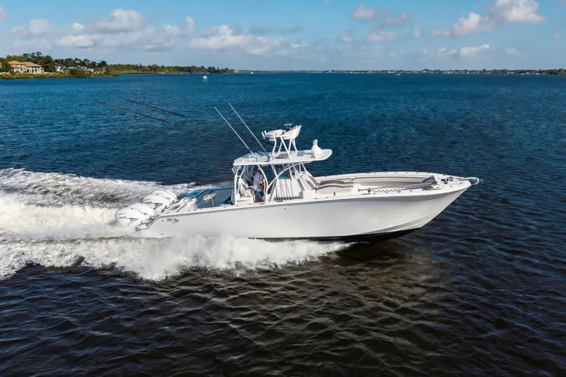Slide: The Image of 2022 SeaHunter 41 CTS boat cruising on open water under a clear sky. - 9