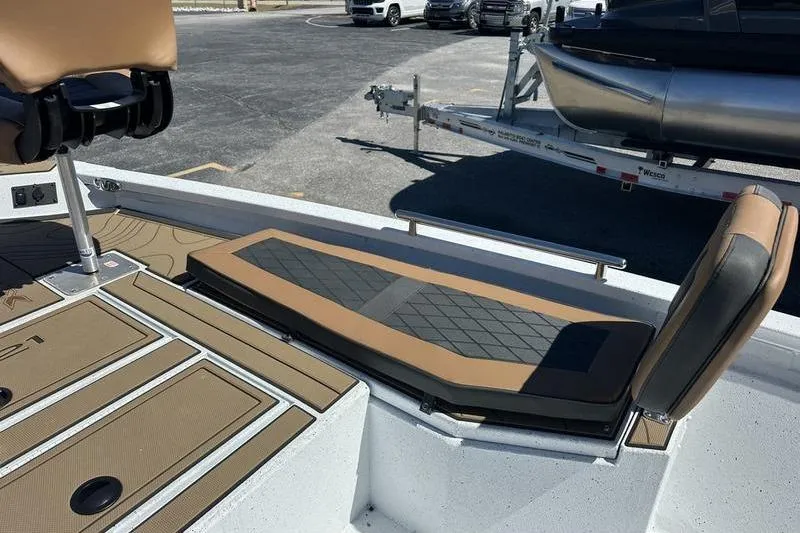 Slide: The Image of 2026 Xpress XR21 Bay boat interior with cushioned seating and storage compartments. - 11