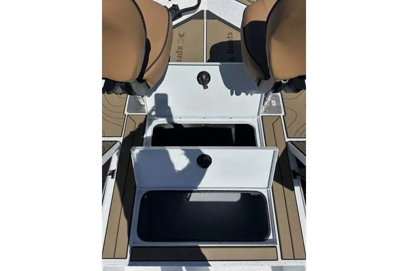 Slide: The Image of 2026 Xpress XR21 Bay boat interior with open storage compartments and seating. - 13