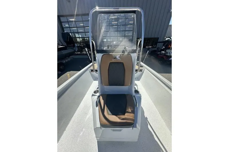 Slide: The Image of 2026 Xpress XR21 Bay boat seat with brown and black upholstery in sunlight. - 14
