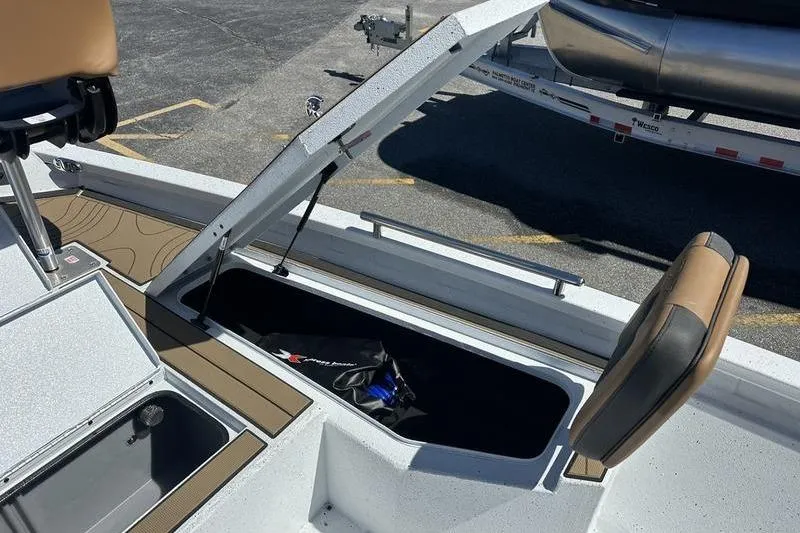 Slide: The Image of Open storage compartment on 2026 Xpress XR21 Bay boat deck. - 15