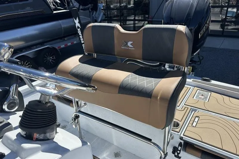 Slide: The Image of 2026 Xpress XR21 Bay boat seat with tan and black upholstery. - 18