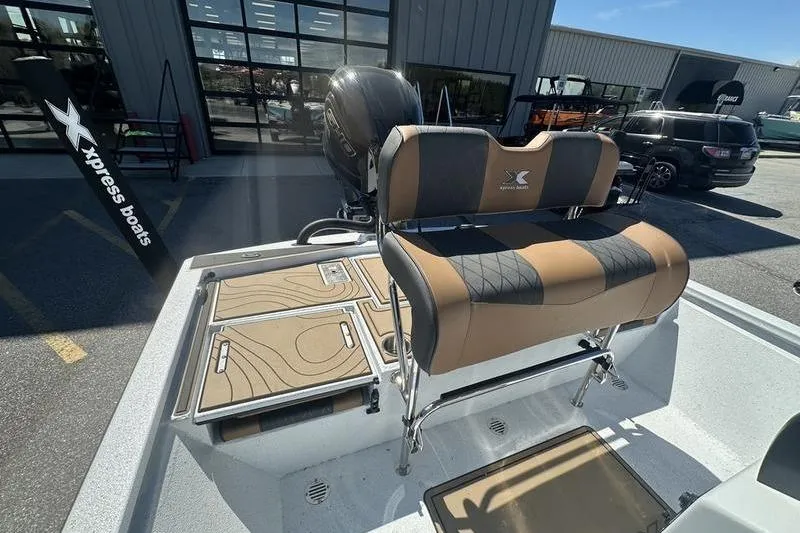 Slide: The Image of 2026 Xpress XR21 Bay boat with cushioned seating and storage compartments. - 19