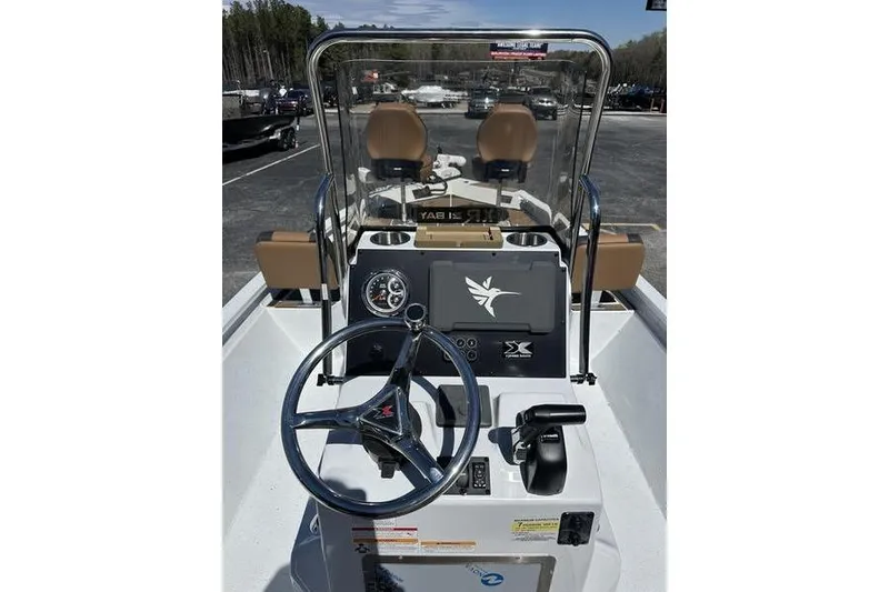 Slide: The Image of 2026 Xpress XR21 Bay boat dashboard with steering wheel and controls. - 3