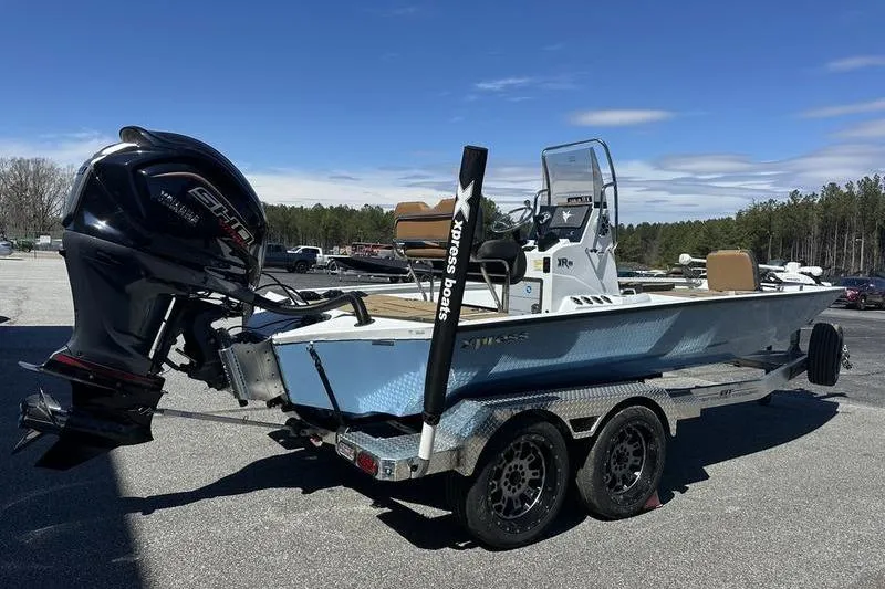 Slide: The Image of 2026 Xpress XR21 Bay boat on trailer with Yamaha outboard motor. - 7
