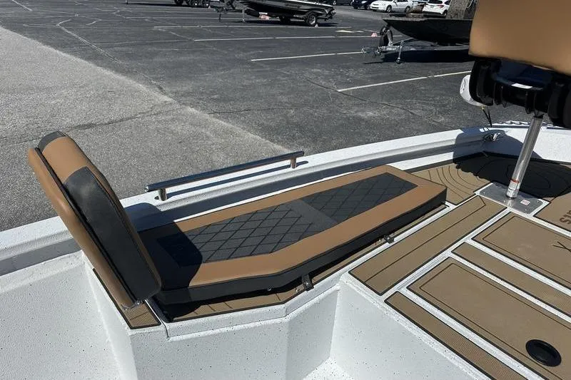Slide: The Image of 2026 Xpress XR21 Bay boat interior with tan seating and deck, parked in a lot. - 8