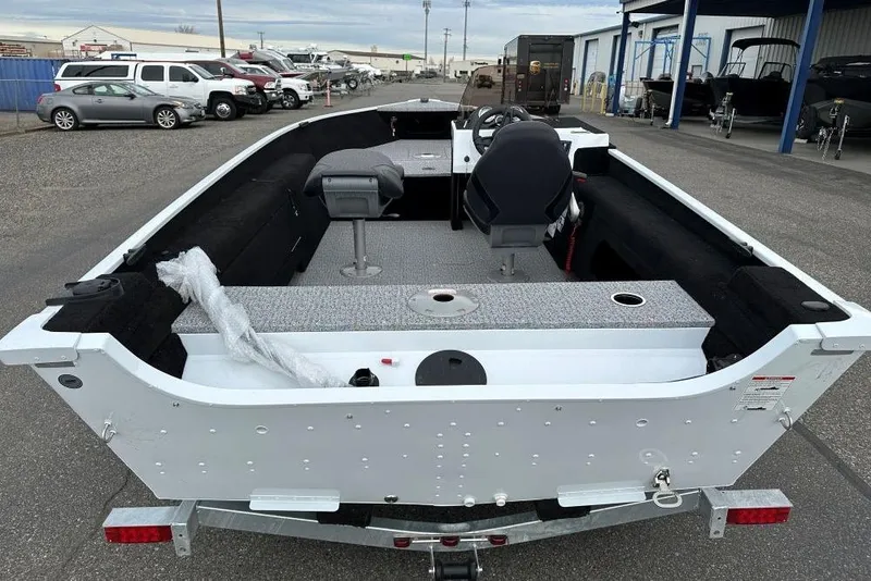Slide: The Image of 2026 Smoker Craft Lazer 161 boat interior, featuring seating and steering console. - 5