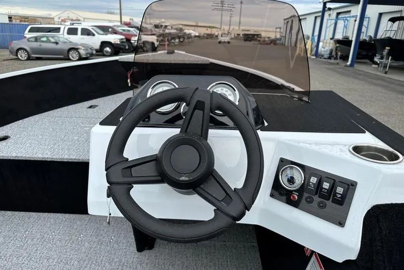 Slide: The Image of 2026 Smoker Craft Lazer 161 boat dashboard with steering wheel and control panel. - 6