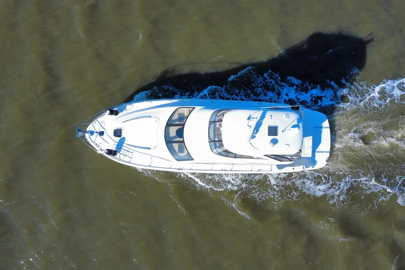 Slide: The Image of Aerial view of 2005 Sea Ray 500 Sedan Bridge yacht cruising on water. - 14