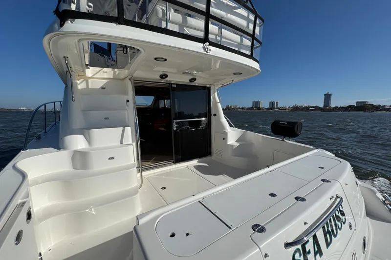 Slide: The Image of 2005 Sea Ray 500 Sedan Bridge yacht on water, featuring spacious deck and sleek design. - 17