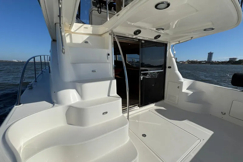 Slide: The Image of 2005 Sea Ray 500 Sedan Bridge yacht with stairs and open cabin door on the water. - 18