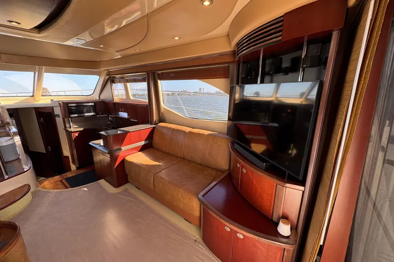 Slide: The Image of Luxurious interior of 2005 Sea Ray 500 Sedan Bridge yacht with leather seating and large windows. - 24