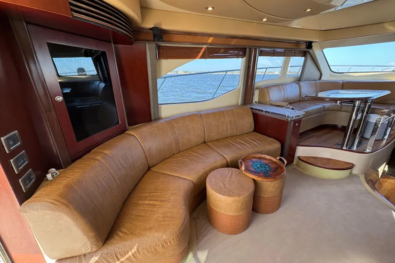 Slide: The Image of Luxurious interior of 2005 Sea Ray 500 Sedan Bridge yacht with leather seating and ocean view. - 25