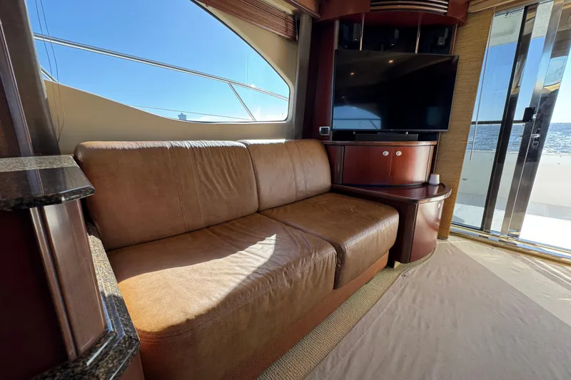 Slide: The Image of Luxurious interior of 2005 Sea Ray 500 Sedan Bridge with leather sofa and TV. - 29