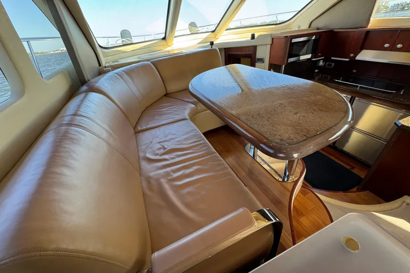 Slide: The Image of Luxurious interior of 2005 Sea Ray 500 Sedan Bridge with leather seating and elegant dining area. - 30