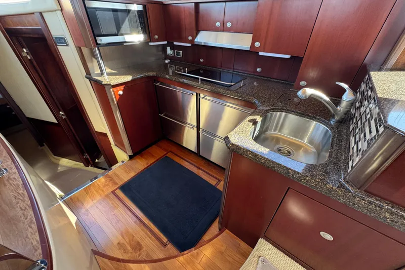 Slide: The Image of Luxurious kitchen interior of 2005 Sea Ray 500 Sedan Bridge yacht with modern appliances. - 31