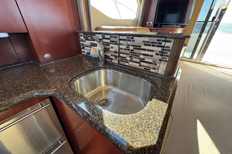 Slide: The Image of Luxurious kitchen sink area on a 2005 Sea Ray 500 Sedan Bridge yacht. - 35
