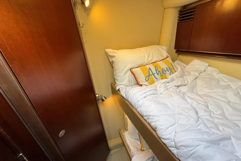 Slide: The Image of Cozy cabin interior of 2005 Sea Ray 500 Sedan Bridge with "Ahoy" pillow. - 38