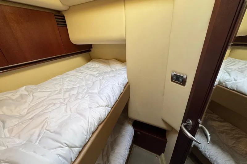 Slide: The Image of 2005 Sea Ray 500 Sedan Bridge cabin with bunk beds and wooden accents. - 39