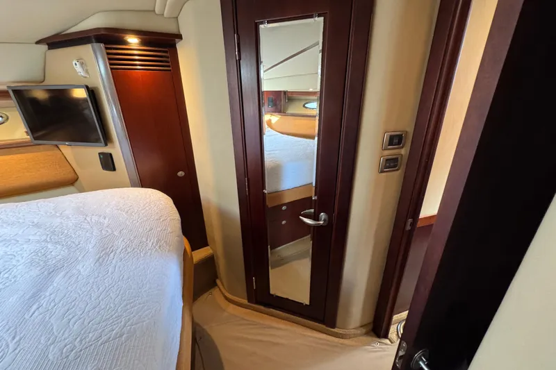 Slide: The Image of Interior of 2005 Sea Ray 500 Sedan Bridge with bed, TV, and mirrored door. - 46