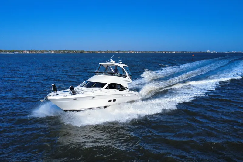 Slide: The Image of 2005 Sea Ray 500 Sedan Bridge cruising on open water under clear blue skies. - 5