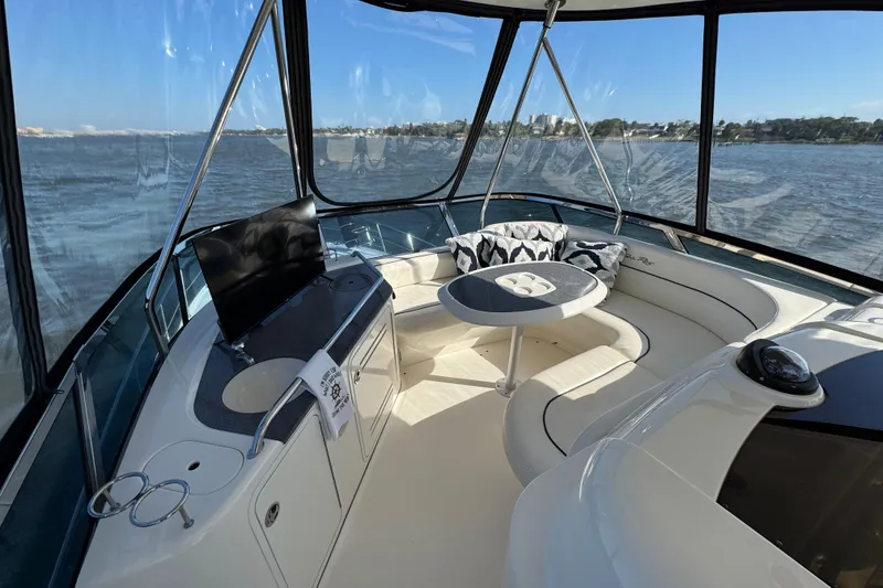 Slide: The Image of Luxurious interior of 2005 Sea Ray 500 Sedan Bridge yacht with panoramic windows. - 50