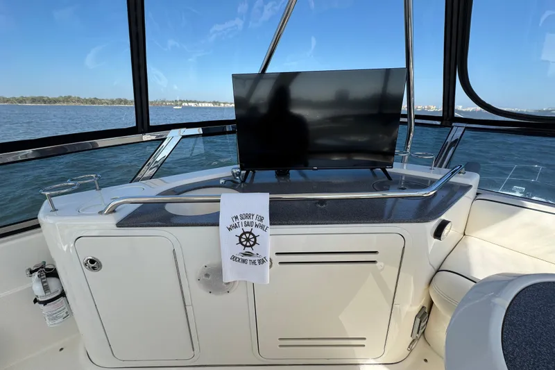 Slide: The Image of 2005 Sea Ray 500 Sedan Bridge interior with TV and humorous towel, ocean view. - 51
