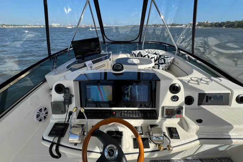 Slide: The Image of Cockpit of 2005 Sea Ray 500 Sedan Bridge with navigation equipment and steering wheel. - 52
